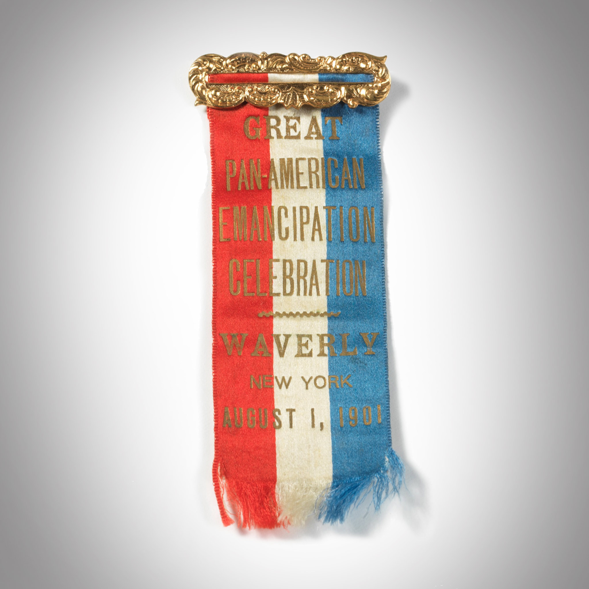 red, white, and blue ribbon with text in gold: Great Pan-American Emancipation Celebration