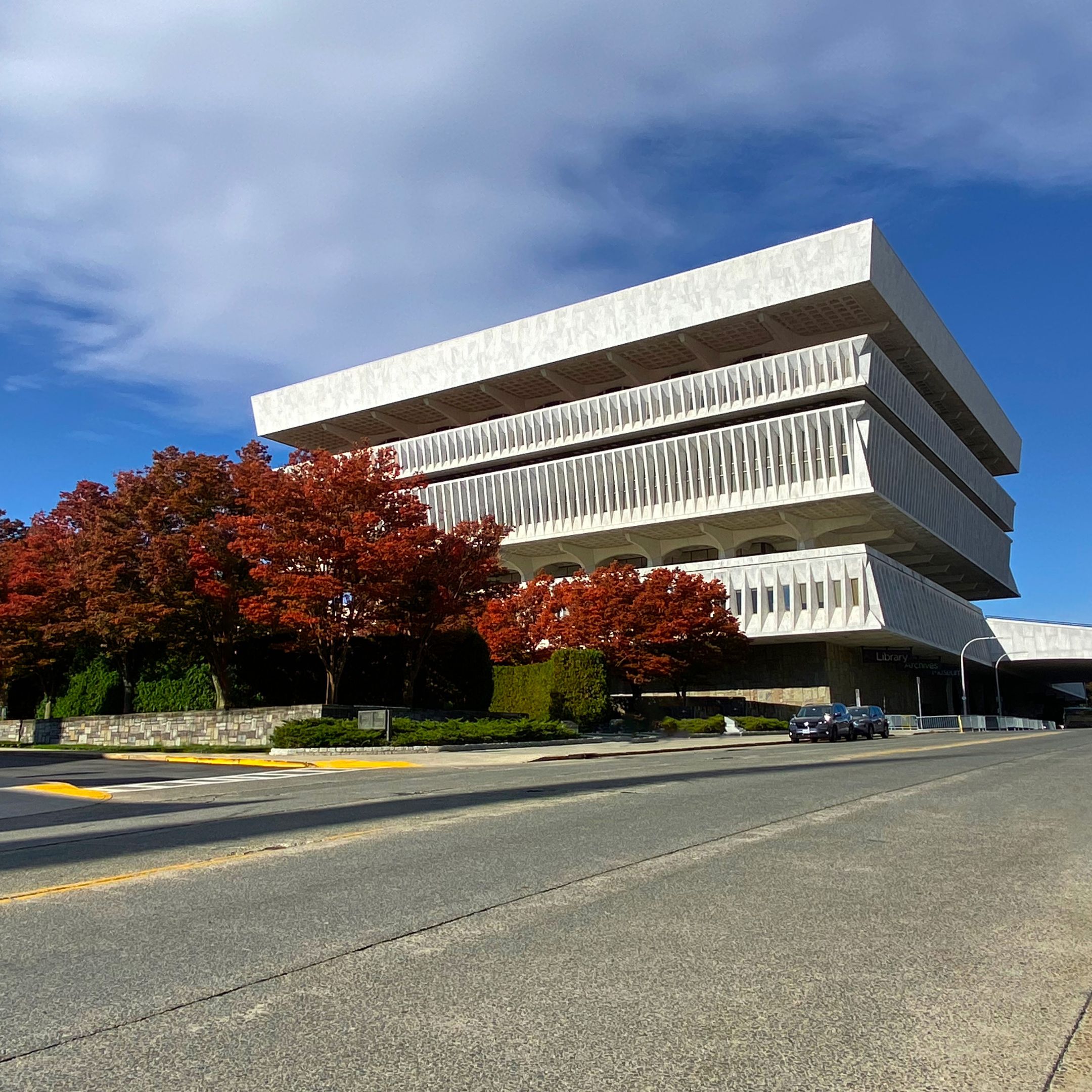Cultural Education Building with red trees in the foreground