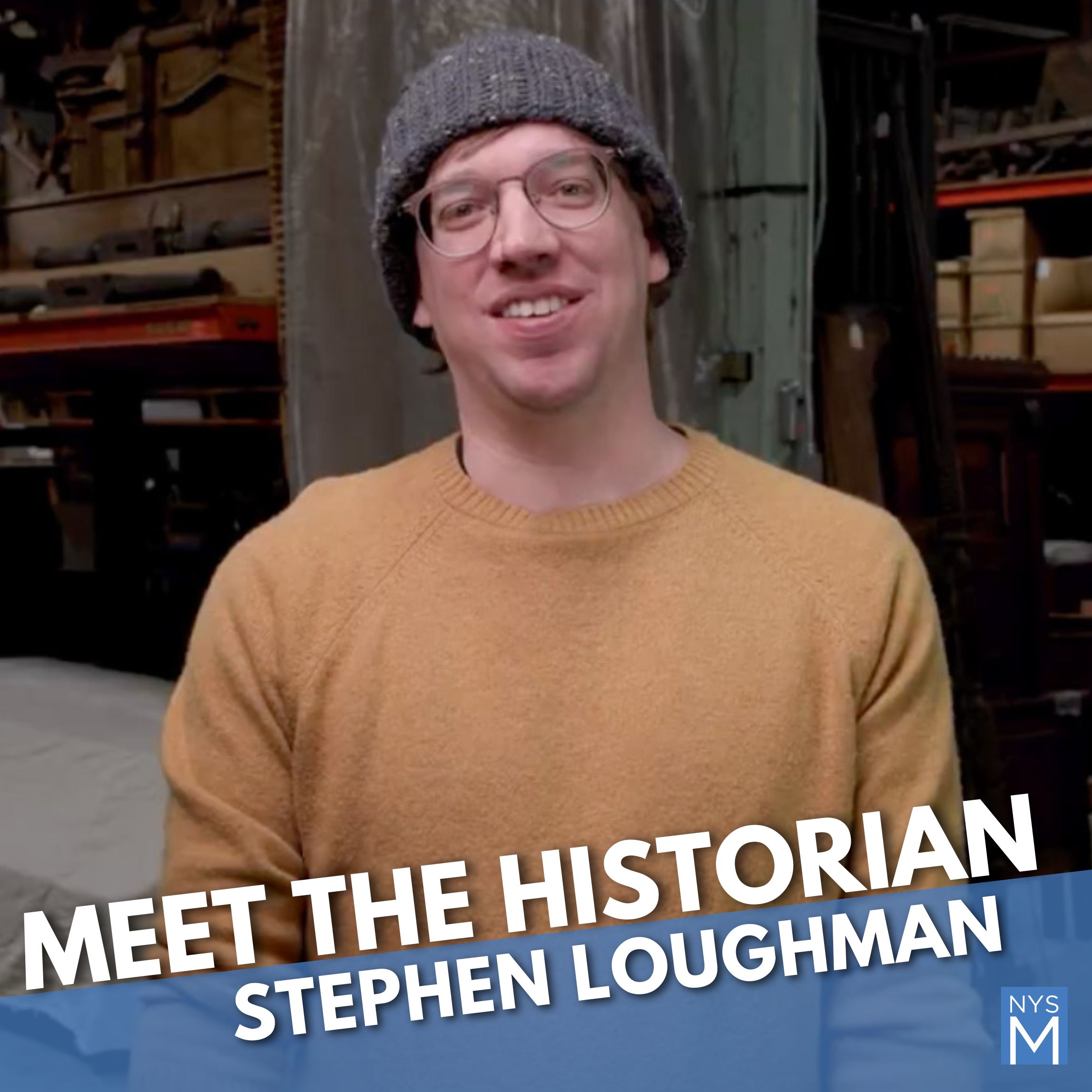 Meet the Historian title text over a photograph of a man wearing glasses in a yellow sweater and brown knit hat