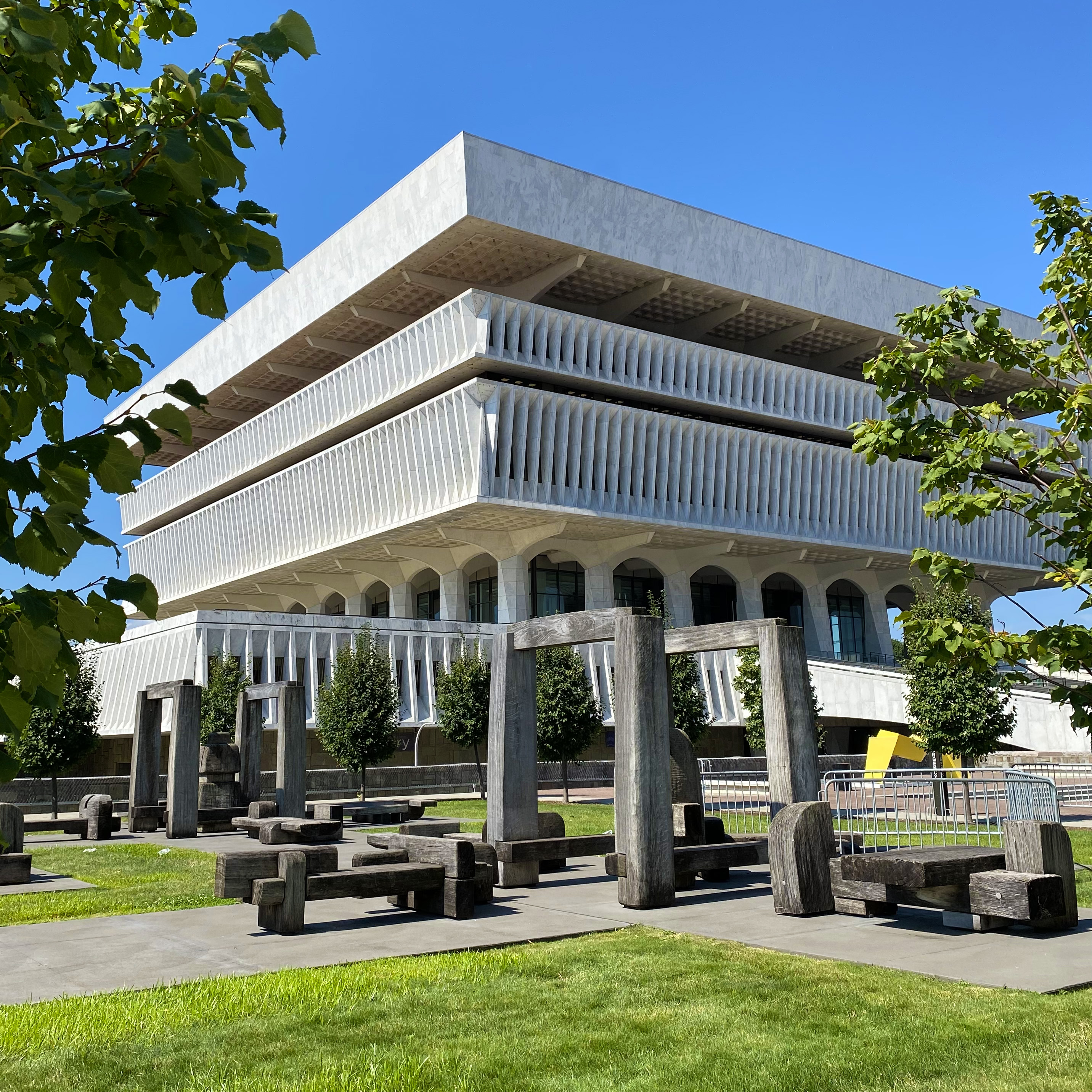 Summertime view of the Cultural Education Center with a sculpture park in the foreground