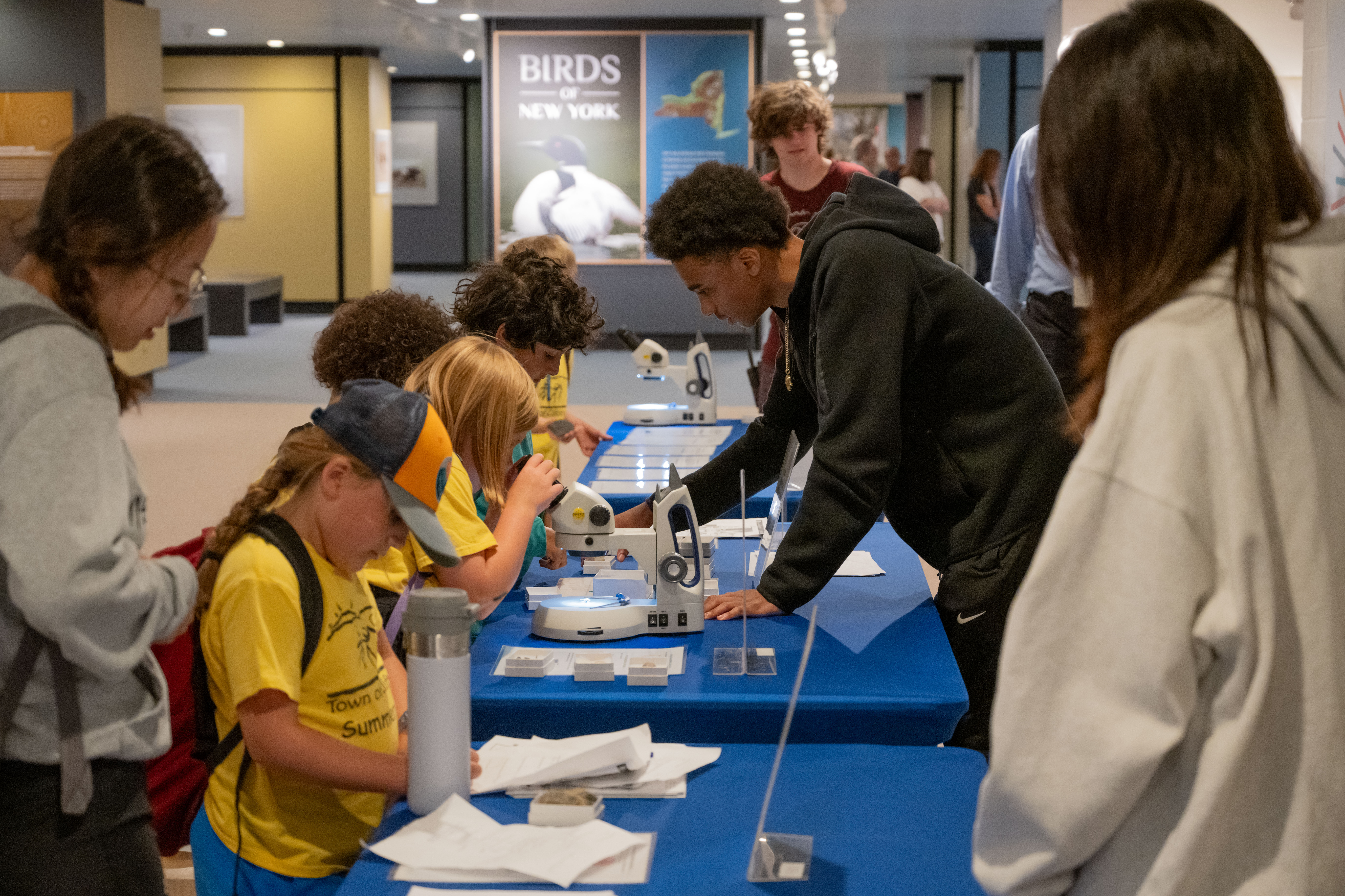 Teen interns assist younger children with crafts and science activities