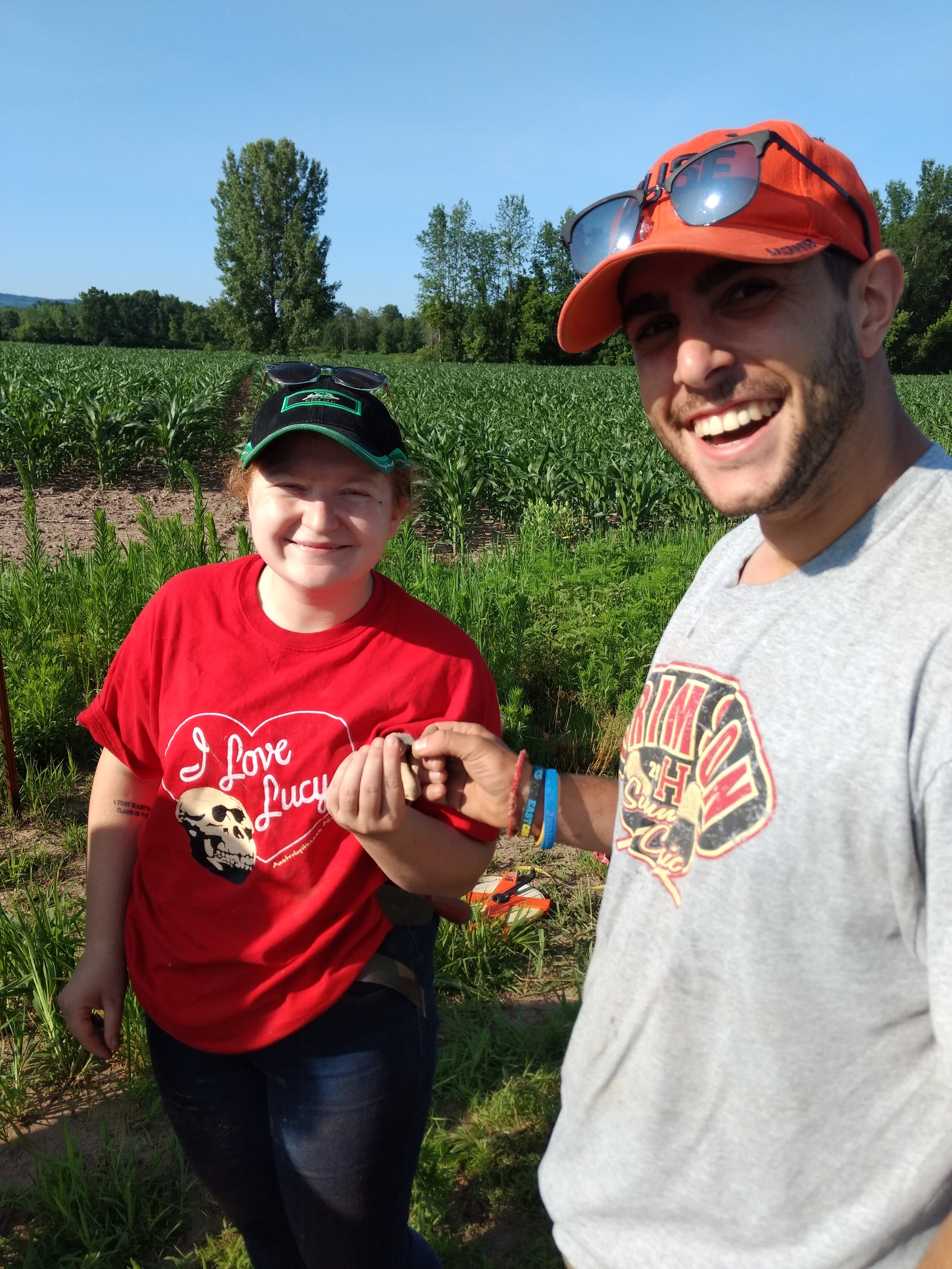 Volunteers Chelsea S. and John G. celebrate their fluted point find at OPS site, July 11, 2019.