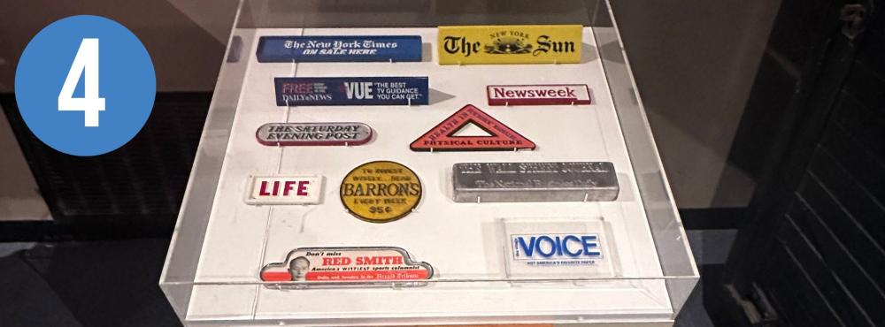 Exhibit case holding newspaper weights