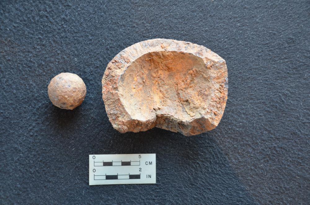 A piece of grape shot (left) and an exploded mortar bomb (right) recovered during scientific excavation at the Lake George Battlefield Park