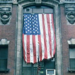 American Flag hanging from building close up 