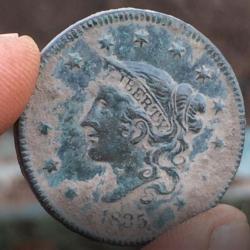 1835 Liberty one cent coin found at the site.