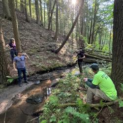 Three individuals in the woods near Caroga Creek