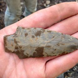 someone holding a projectile point