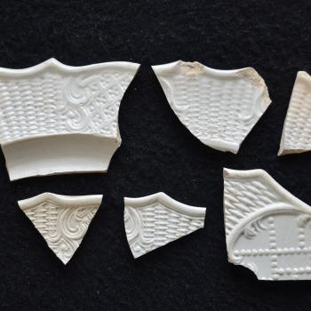 Several molded sherds of white salt-glazed stoneware, all with a dot, diaper and basket pattern. These ceramic artifacts were recovered from a kitchen dump site, likely associated with a 1760s headquarters post. 