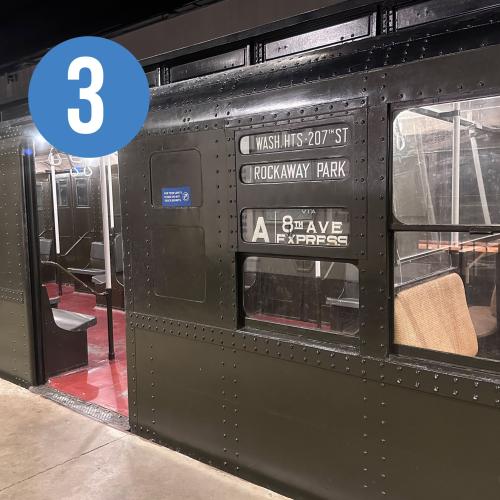 exterior of a train with its door open and signage "A 8th Ave EXPRESS"