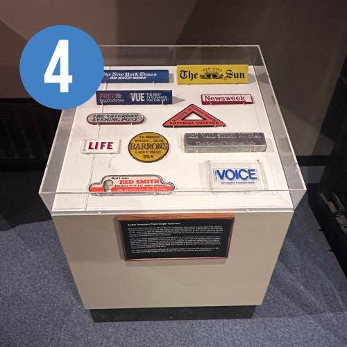 exhibit case containing a variety of newspaper weights