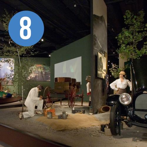 Gallery view of mannequins in an Adirondack setting