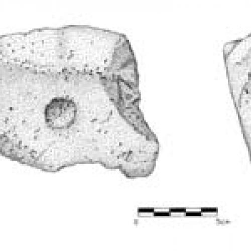 An illustration of a pitted stone artifact.