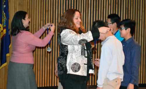 Administrators presenting medals to two students on History Day