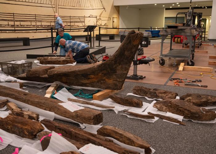 people assembling the wooden Revolutionary War gunboat. 