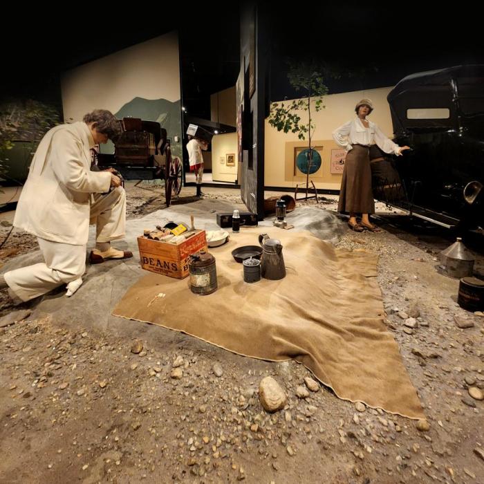 Gallery view of mannequins in an Adirondack camping setting
