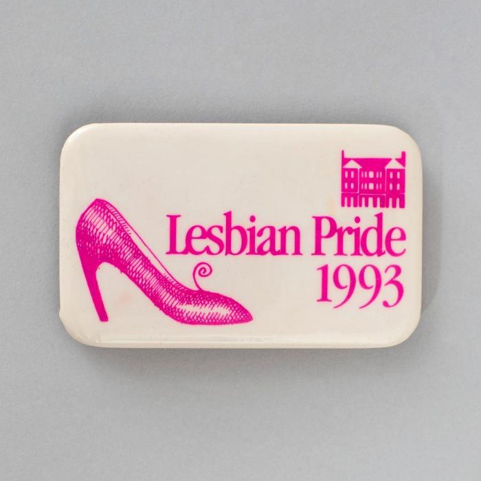 white pin labeld "Lesbian Pride 1993" with a pink high heel shoe